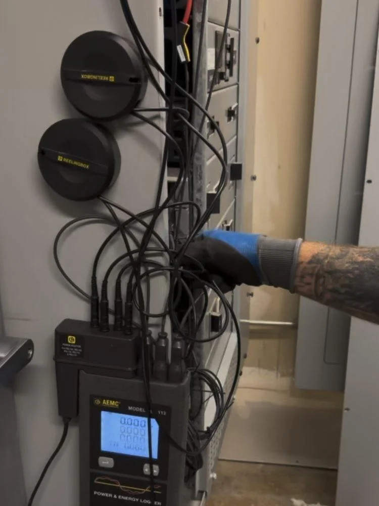 Portable energy logger connected during commercial-building audit fieldwork